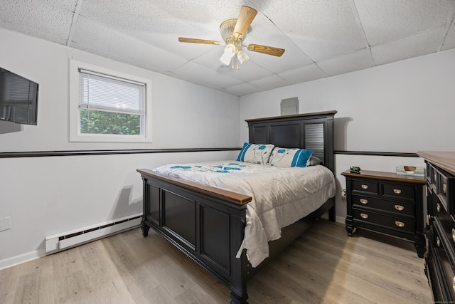 489 Thomaston Rd, Watertown, CT 06795 - bedroom with a baseboard heating unit, a drop ceiling, light wood-type flooring, and ceiling fan