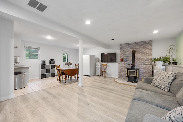 489 Thomaston Rd, Watertown, CT 06795 - living area featuring a wood stove, light wood-style flooring, and recessed lighting