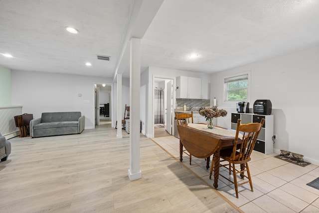 489 Thomaston Rd, Watertown, CT 06795 - dining space with recessed lighting, a baseboard radiator, and light wood finished floors
