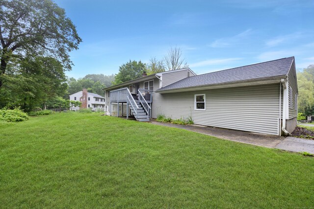 489 Thomaston Rd, Watertown, CT 06795 - rear view of house with stairway, a lawn, a wooden deck, and roof with shingles