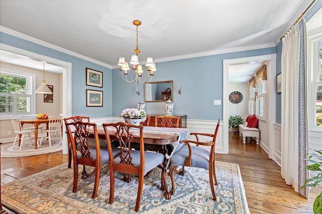 5 Lookout Rd, Norwalk, CT 06850 - dining space with light wood-style flooring, a chandelier, crown molding, and wainscoting