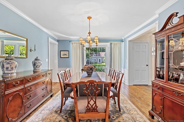 5 Lookout Rd, Norwalk, CT 06850 - dining space featuring a chandelier, healthy amount of natural light, light wood-style floors, ornamental molding, and a wainscoted wall
