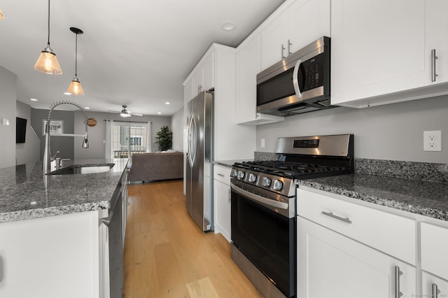 64 Scotch Cap Rd Unit 173, Waterford, CT 06375 - kitchen with stainless steel appliances, light wood-style floors, a ceiling fan, white cabinets, and dark stone countertops