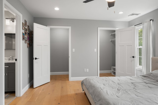 64 Scotch Cap Rd Unit 173, Waterford, CT 06375 - bedroom featuring light wood-type flooring, a walk in closet, recessed lighting, ensuite bath, and a closet