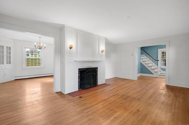 133 Griswold Rd, Wethersfield, CT 06109 - unfurnished living room with baseboard heating, light wood-style floors, a chandelier, stairway, and a brick fireplace