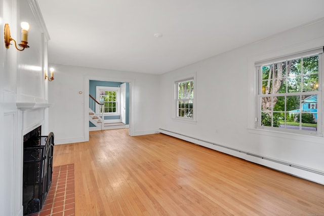 133 Griswold Rd, Wethersfield, CT 06109 - unfurnished living room featuring a baseboard heating unit, a fireplace with flush hearth, light wood finished floors, and plenty of natural light