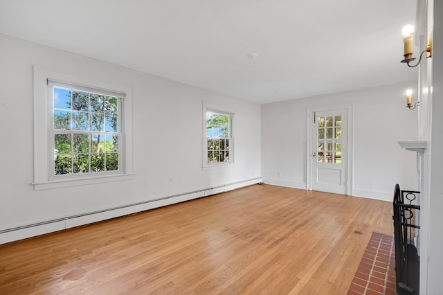 133 Griswold Rd, Wethersfield, CT 06109 - unfurnished living room with wood-type flooring, healthy amount of natural light, and baseboard heating