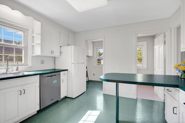 133 Griswold Rd, Wethersfield, CT 06109 - kitchen featuring stainless steel dishwasher, freestanding refrigerator, white cabinets, and dark countertops