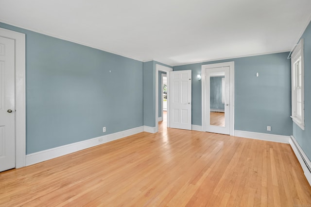 133 Griswold Rd, Wethersfield, CT 06109 - unfurnished bedroom featuring a baseboard heating unit, light wood finished floors, and ornamental molding