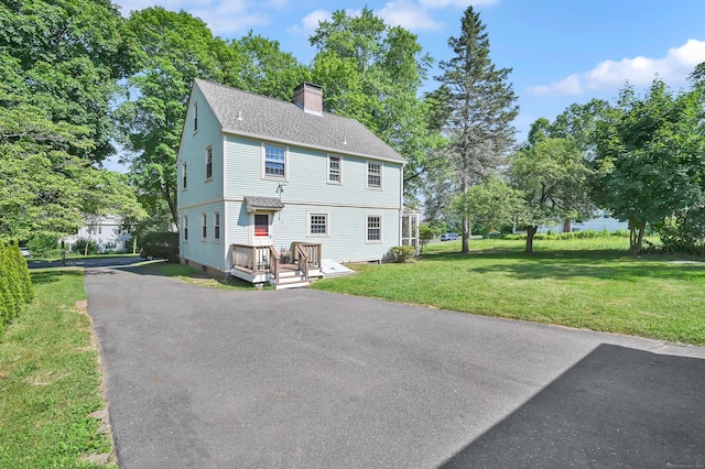 133 Griswold Rd, Wethersfield, CT 06109 - rear view of house with a chimney, a yard, and roof with shingles
