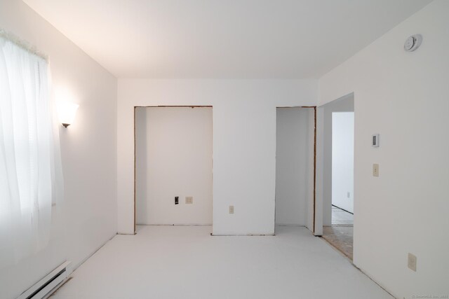 510 S St S, Bristol, CT 06010 - unfurnished bedroom featuring a baseboard radiator and multiple closets