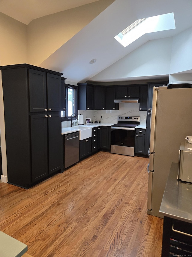 118 Harding Ave, Newington, CT 06111 - kitchen featuring appliances with stainless steel finishes, a skylight, light countertops, lofted ceiling, and under cabinet range hood