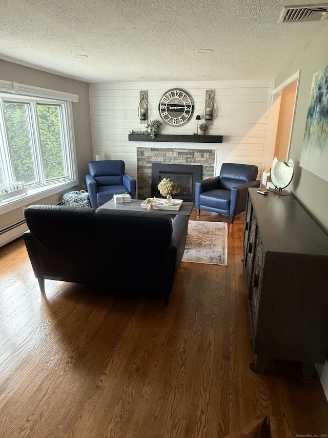 118 Harding Ave, Newington, CT 06111 - living area featuring dark wood-style flooring, a fireplace, a textured ceiling, and wooden walls