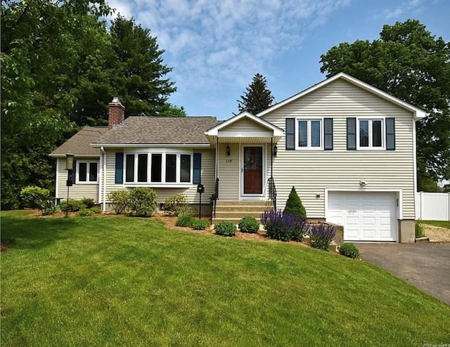 118 Harding Ave, Newington, CT 06111 - tri-level home featuring driveway, a garage, and a chimney