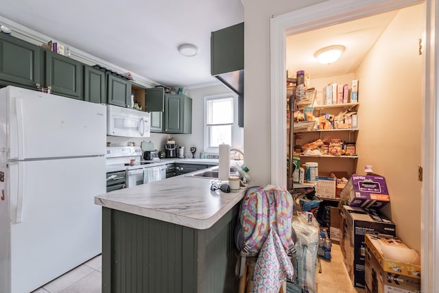 21 Bigelow Ave, Enfield, CT 06082 - kitchen with white appliances, green cabinetry, a peninsula, light countertops, and light tile patterned flooring