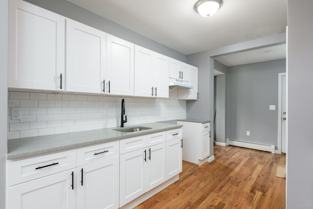 68 School St, Hartford, CT 06106 - kitchen featuring a baseboard heating unit, tasteful backsplash, white cabinetry, light wood finished floors, and light stone countertops