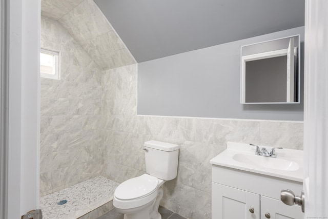 68 School St, Hartford, CT 06106 - full bathroom featuring vanity, tiled shower, vaulted ceiling, and tile walls