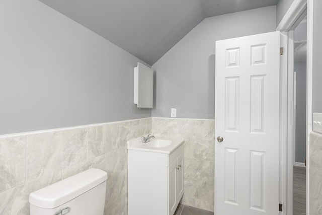 68 School St, Hartford, CT 06106 - half bath with vanity, tile walls, lofted ceiling, and a wainscoted wall