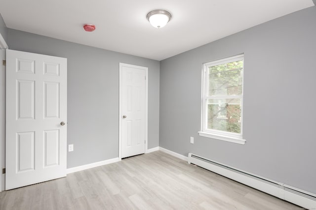 68 School St, Hartford, CT 06106 - unfurnished bedroom featuring baseboard heating and light wood-style floors
