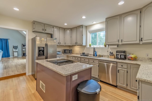 263 New Britain Ave, Newington, CT 06111 - kitchen with stainless steel appliances, light wood-style floors, light stone countertops, recessed lighting, and a center island