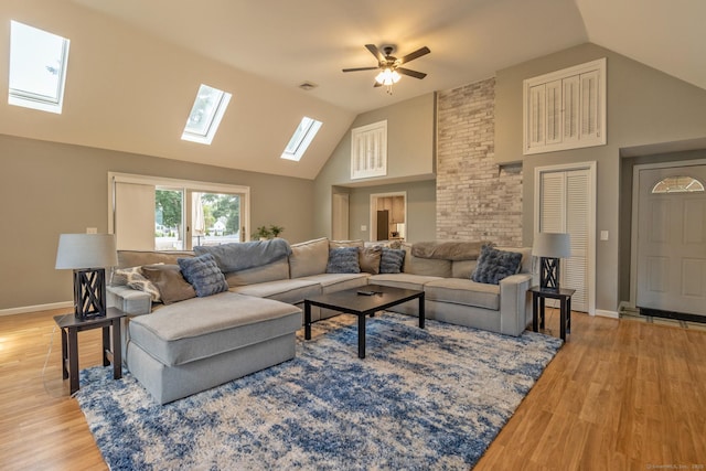 263 New Britain Ave, Newington, CT 06111 - living room featuring a skylight, wood finished floors, ceiling fan, and high vaulted ceiling