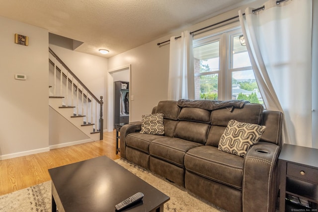 263 New Britain Ave, Newington, CT 06111 - living room with light wood-style flooring, stairs, and a textured ceiling
