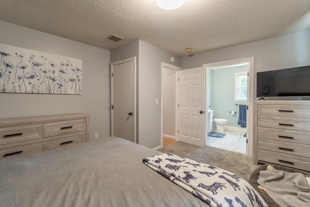 263 New Britain Ave, Newington, CT 06111 - carpeted bedroom with ensuite bath and a textured ceiling