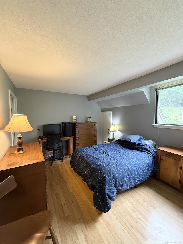 13 Heritage Vlg Unit E, Southbury, CT 06488 - bedroom featuring wood finished floors, a textured ceiling, and a desk