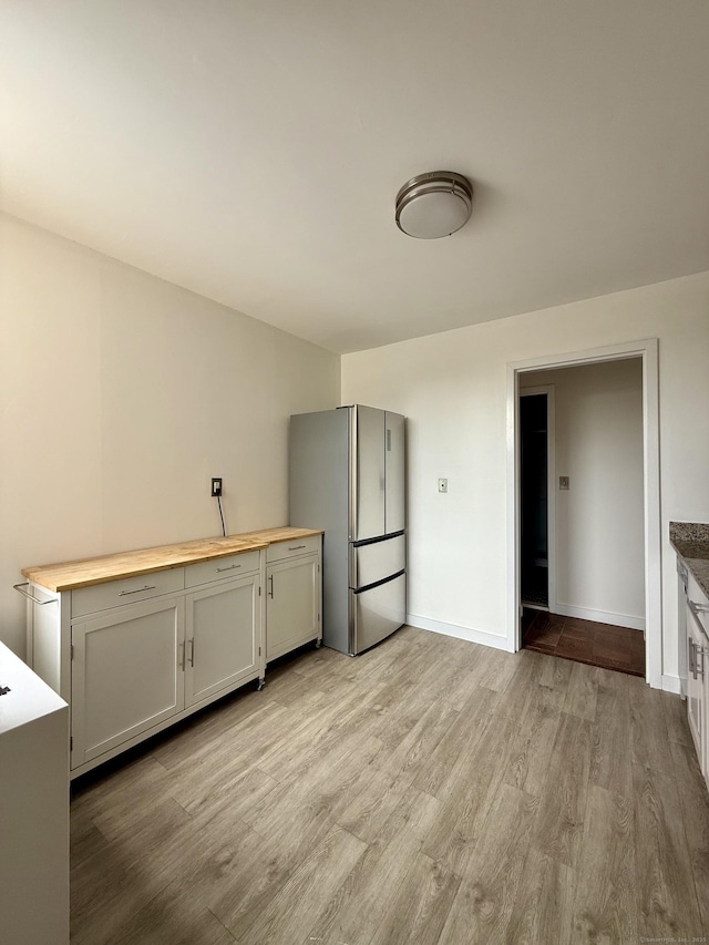 1 Strawberry Hill Ct Apt 2D, Stamford, CT 06902 - kitchen with freestanding refrigerator, butcher block counters, and light wood finished floors