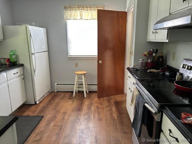 450 Toll Gate Rd, Groton, CT 06340 - kitchen with stainless steel range with electric stovetop, under cabinet range hood, a baseboard radiator, and dark countertops