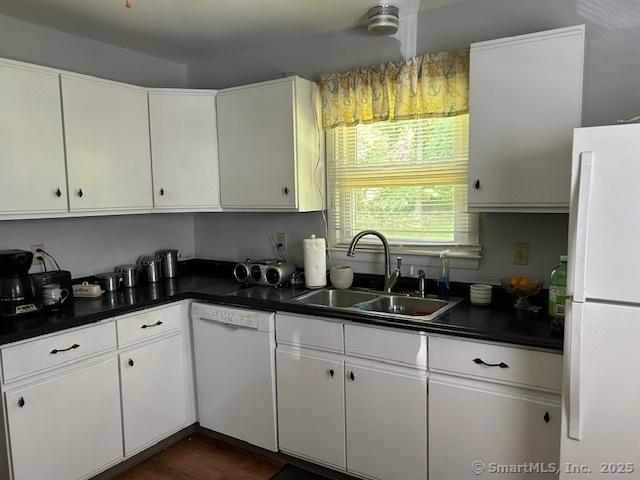 450 Toll Gate Rd, Groton, CT 06340 - kitchen featuring white appliances, dark countertops, and white cabinetry