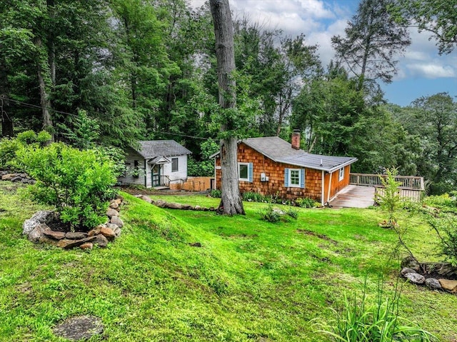 69 Forest Dr, Newtown, CT 06482 - back of house with a chimney, a deck, a lawn, and an outbuilding