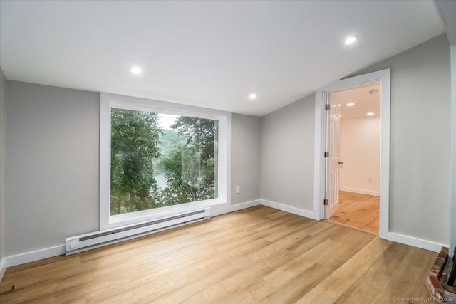 69 Forest Dr, Newtown, CT 06482 - spare room featuring a baseboard heating unit, wood finished floors, recessed lighting, and lofted ceiling