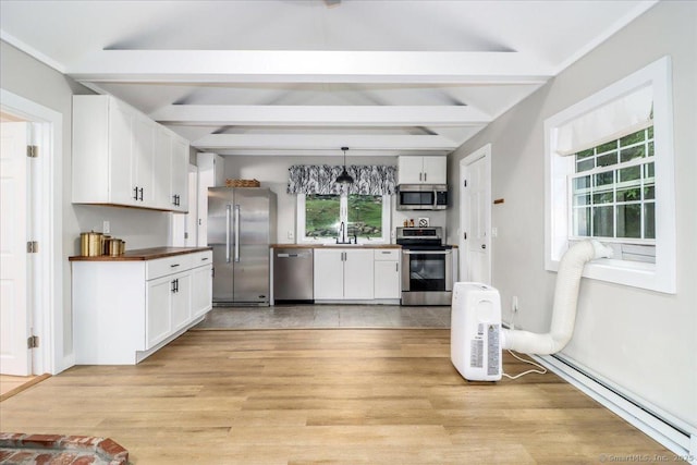 69 Forest Dr, Newtown, CT 06482 - kitchen with stainless steel appliances, white cabinetry, beamed ceiling, light wood finished floors, and hanging light fixtures