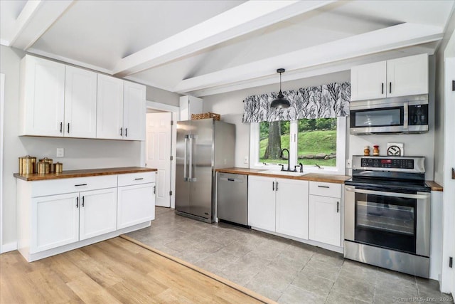 69 Forest Dr, Newtown, CT 06482 - kitchen featuring stainless steel appliances, wooden counters, beamed ceiling, white cabinets, and decorative light fixtures