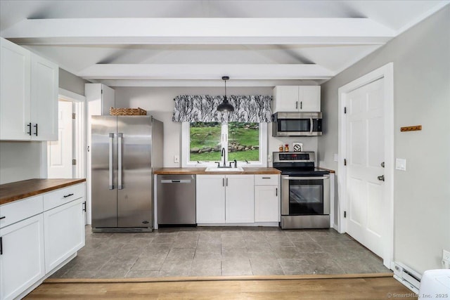 69 Forest Dr, Newtown, CT 06482 - kitchen with stainless steel appliances, butcher block counters, white cabinets, beamed ceiling, and a baseboard radiator