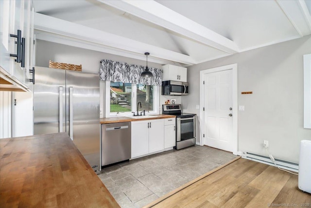 69 Forest Dr, Newtown, CT 06482 - kitchen with butcher block countertops, stainless steel appliances, baseboard heating, beamed ceiling, and white cabinets