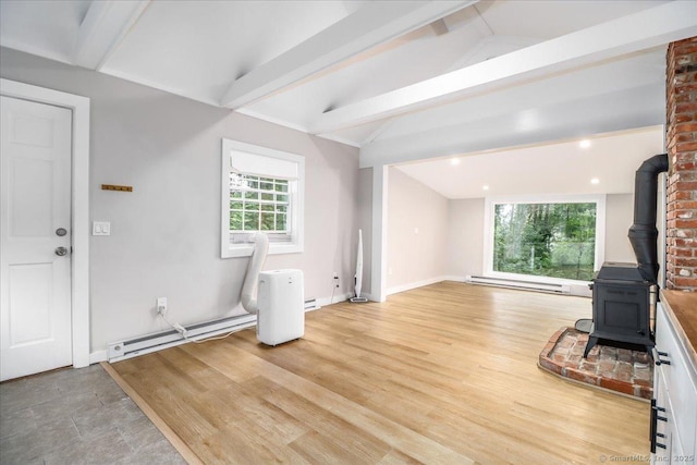 69 Forest Dr, Newtown, CT 06482 - unfurnished living room featuring a wood stove, baseboard heating, and light wood finished floors