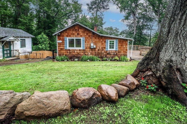 69 Forest Dr, Newtown, CT 06482 - view of front facade with a wooden deck, a chimney, and a front lawn