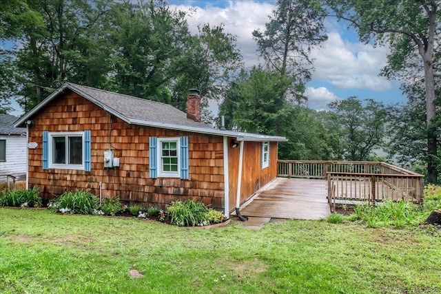 69 Forest Dr, Newtown, CT 06482 - view of side of property featuring a chimney, a wooden deck, a yard, and a shingled roof
