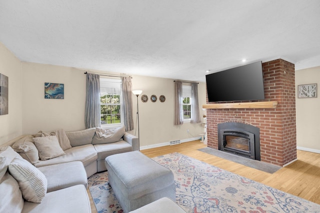 24 Cambridge Dr, Southington, CT 06489 - living room featuring wood finished floors, plenty of natural light, a brick fireplace, and recessed lighting