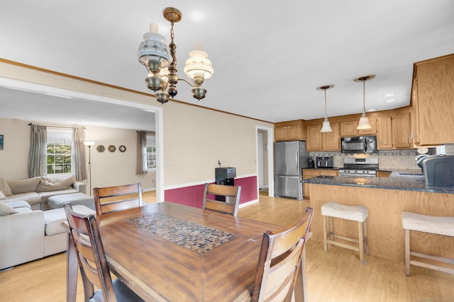 24 Cambridge Dr, Southington, CT 06489 - dining area with a chandelier and light wood-style floors