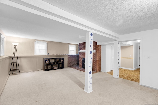 24 Cambridge Dr, Southington, CT 06489 - below grade area with carpet, a brick fireplace, and a textured ceiling