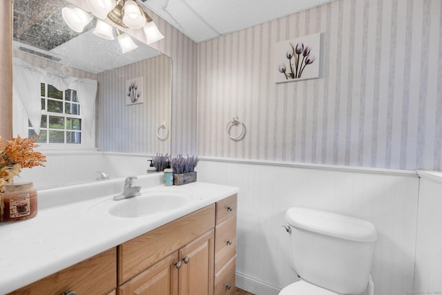 24 Cambridge Dr, Southington, CT 06489 - half bath featuring wallpapered walls, a wainscoted wall, and vanity
