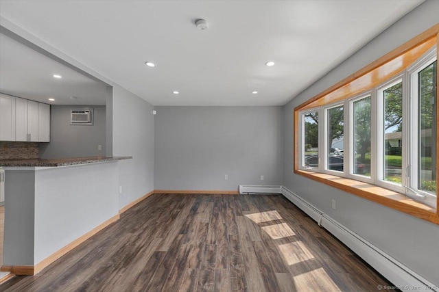 29 Pembroke Rd, Hamden, CT 06514 - unfurnished living room with a baseboard heating unit, dark wood-style floors, recessed lighting, and an AC wall unit