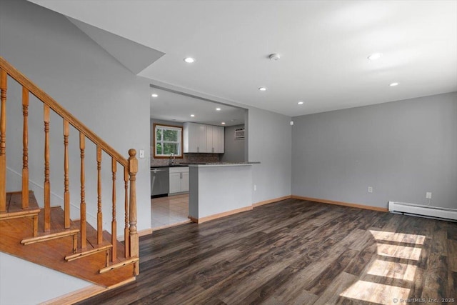 29 Pembroke Rd, Hamden, CT 06514 - unfurnished living room featuring a baseboard radiator, wood finished floors, recessed lighting, and stairs