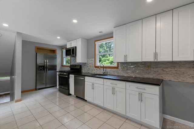 29 Pembroke Rd, Hamden, CT 06514 - kitchen featuring stainless steel appliances, backsplash, dark countertops, white cabinets, and recessed lighting