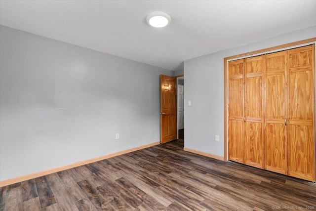 29 Pembroke Rd, Hamden, CT 06514 - unfurnished bedroom with dark wood-style flooring and a closet