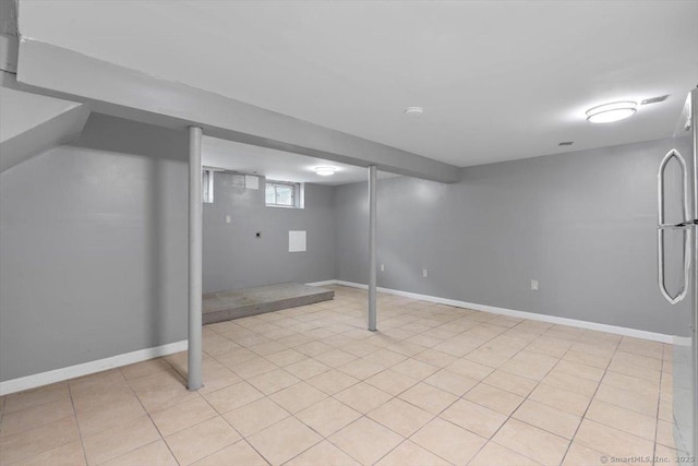 29 Pembroke Rd, Hamden, CT 06514 - below grade area featuring freestanding refrigerator and baseboards