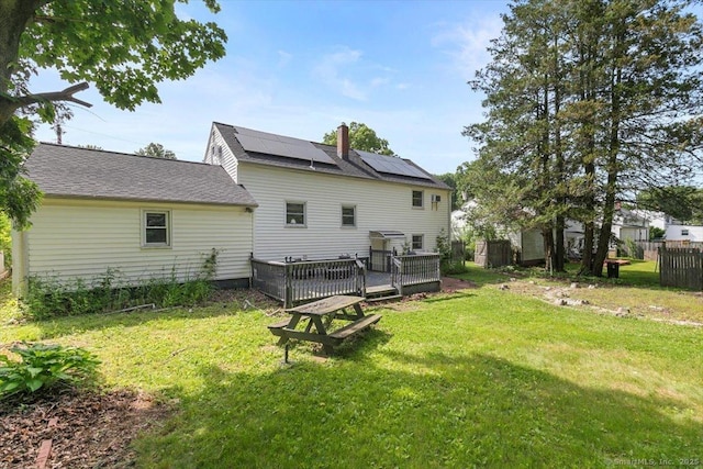 29 Pembroke Rd, Hamden, CT 06514 - rear view of house with solar panels, a deck, and a chimney